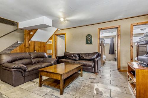 a living room with a couch and a table at Mountain View-Backyard-Air-Conditioning-BBQ-15mins walk Blue Mountain Village in Blue Mountains