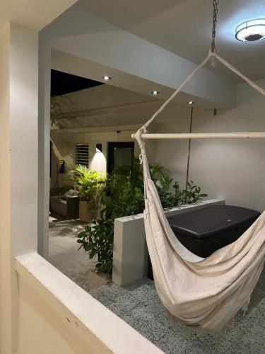 a hammock hanging in a room with plants at Villa Bamboo in San Juan