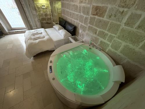 a bathroom with a tub in the middle of a room at Barbacana Monopoli in Monopoli