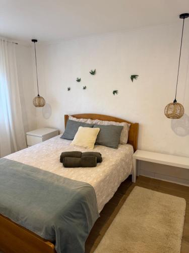 a bedroom with a bed with birds on the wall at Casa Oliveira in Silves