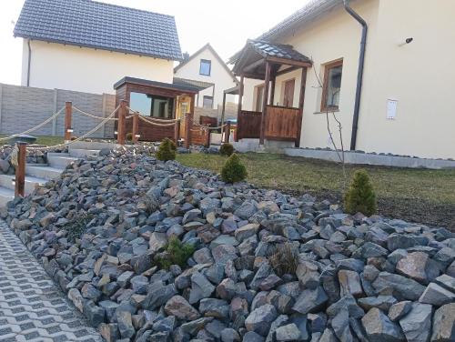 a rock garden in front of a house at Letnisko domek z Sauną i Balią in Lubawka