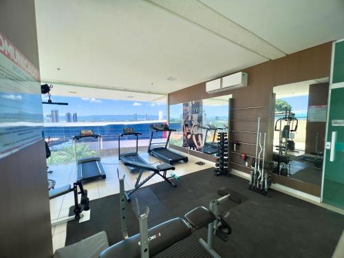a gym with two treadmills and a large window at Studio 603 Estilo, conforto e ótima localização in Juazeiro do Norte