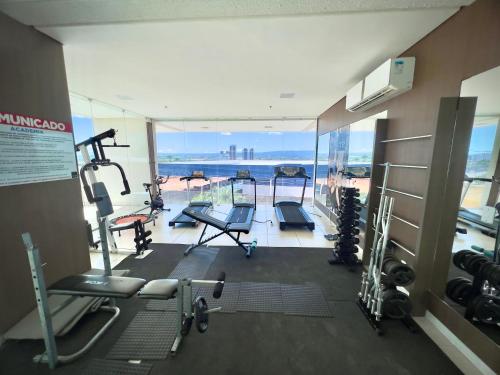 a gym with cardio equipment and a view of the ocean at Studio 603 Estilo, conforto e ótima localização in Juazeiro do Norte