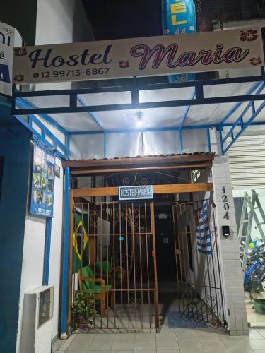 aoked marina entrance to a building with a gate at Hostel Maria in Ubatuba