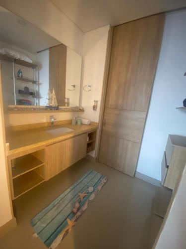 a bathroom with a sink and a mirror at Reserva del Mar 539 in Santa Marta