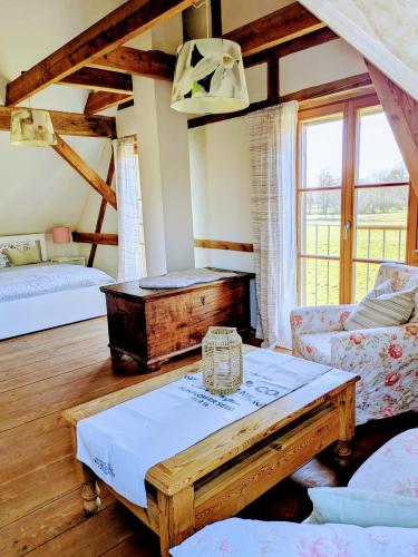 a living room with a table and a couch at Liljas Haus im Spreewald in Burg