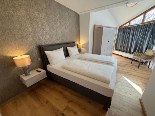 a bedroom with a bed with a lamp and a window at Residence Loft in Friedrichshafen