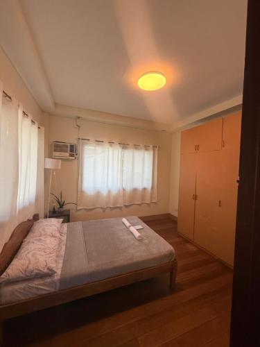 a bedroom with a bed and a light on the ceiling at The RM Homestay in Baclayon