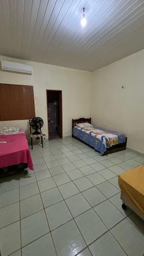 a room with a bed and a table in it at Casa Aguiar in Santarém