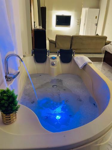 a jacuzzi tub with blue water in a room at Golden mask pyramids inn in Cairo