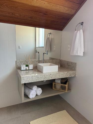 a bathroom with a sink and a mirror at Loft Toscana in Santa Teresa