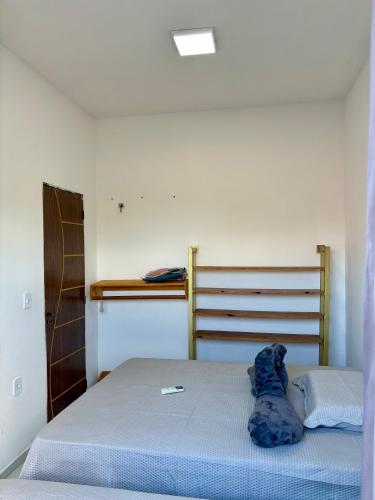 a bedroom with a bed with a blue blanket on it at Varanda das Dunas in Santo Amaro