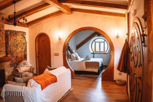 a bedroom with a bed and a large mirror at La Comarca de Vératton in Villanueva de la Vera
