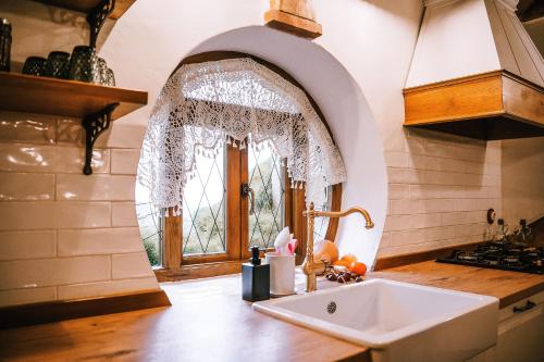 a kitchen with a sink and a window at La Comarca de Vératton in Villanueva de la Vera