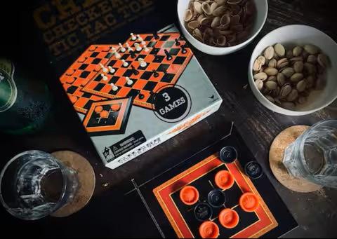 a table with a chess game and bowls of food at Caba La Union Gulfside Cottage C2 in Caba