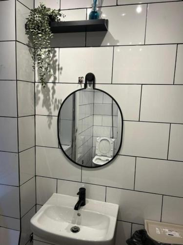 a bathroom with a mirror and a sink at Samps Hostel in Lisbon