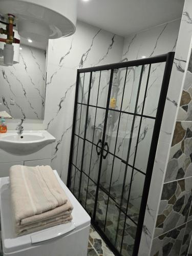 a white bathroom with a sink and a shower at Studio modern climatise in Bourgoin