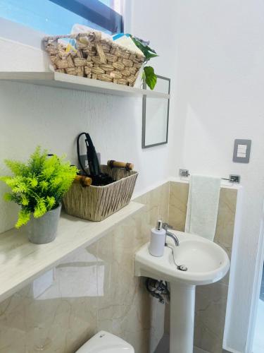 a bathroom with a white toilet and a sink at Casa Migueleña in San Miguel
