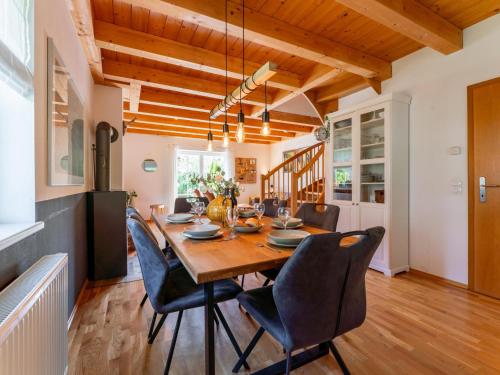 a kitchen and dining room with a wooden table and chairs at Gailblick in Kötschach