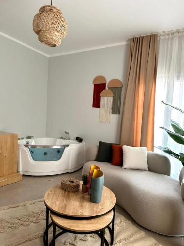 a living room with a couch and a table and a tub at Babushka Boutique Hotel-Dahab in Dahab