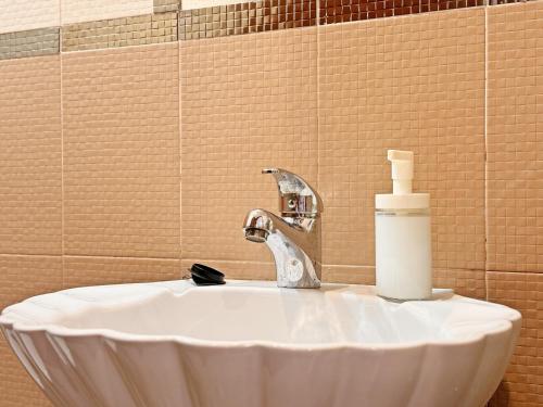 a bathroom sink with a soap bottle on it at Apartamentos Rurales LLeguera in Llanes