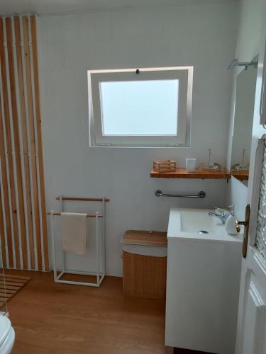 a bathroom with a sink and a window at Sea Bay House in Lagoa