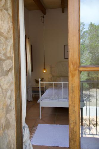 a bedroom with a bed in a room with a window at Finca Ses Eres in Artá