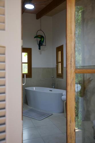 a large white tub in a bathroom with a window at Finca Ses Eres in Artá