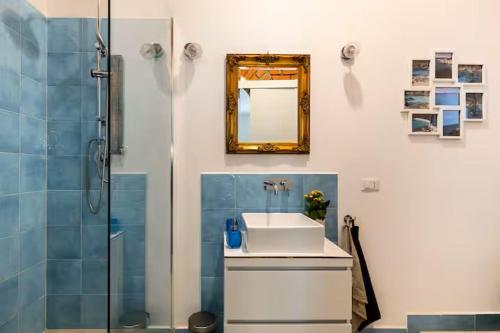 a bathroom with a sink and a shower with a mirror at Appartamenti Milù - Milù Holidays La Maddalena in La Maddalena