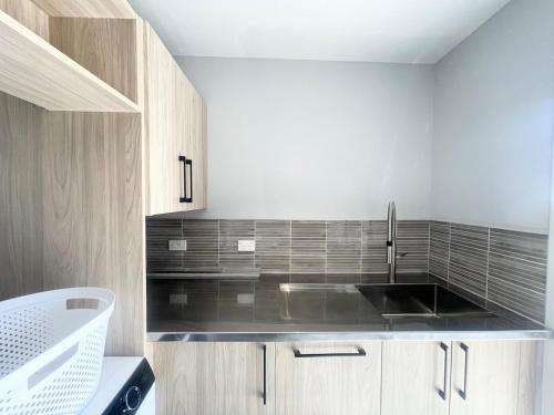 a kitchen with a sink and a counter top at Beachside Bliss - Modern Luxury in Napier