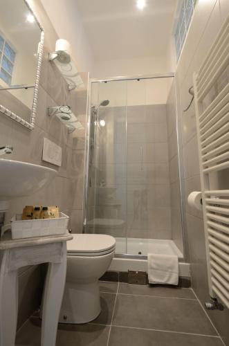 a white bathroom with a shower and a toilet at RESIDENZA DEGLI ARTISTI - La Maison in Trieste