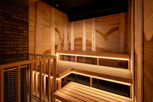 a wooden sauna with wooden stairs in a room at Niseko Northern Resort, An'nupuri in Niseko
