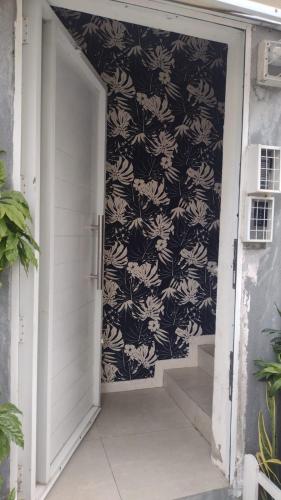 an open door with a black and white wall at Lofts portal 225 unid 01 in Recife
