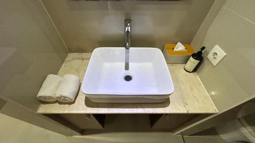 a white sink sitting on a counter in a bathroom at Balangan Surf Resort in Jimbaran