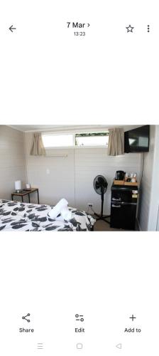 a room with a bed and a window at Raglan park rest and stay cabins - Private studio in Raglan