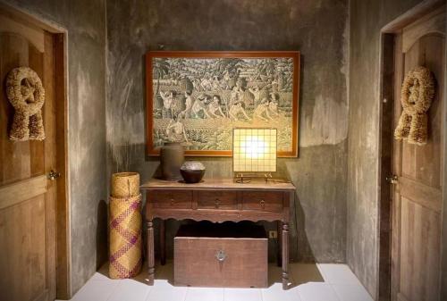 a room with a table with a painting on the wall at Caba La Union Gulfside Cottage C3 in Caba