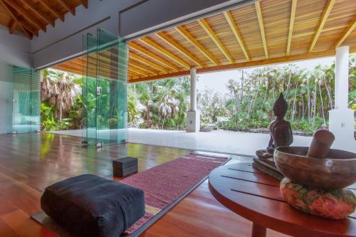 a living room with a table and a bowl on the floor at Naïa Resort and Spa in Placencia Village