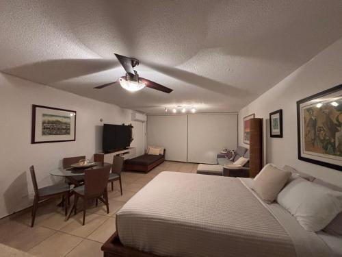 a bedroom with a bed and a dining room at Ocean view Studio Marina Lanais in Fajardo