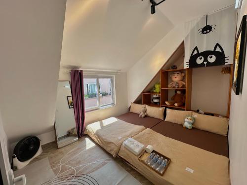 a bedroom with a bed and a cat shelf at 1 House 2 in Da Lat