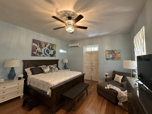a bedroom with a bed and a ceiling fan at BellaDonna By The Bay in Bridgetown