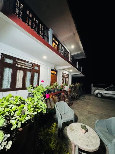 a room with a table and chairs and plants at Vedanth Retreat Homestay in Kalimpong