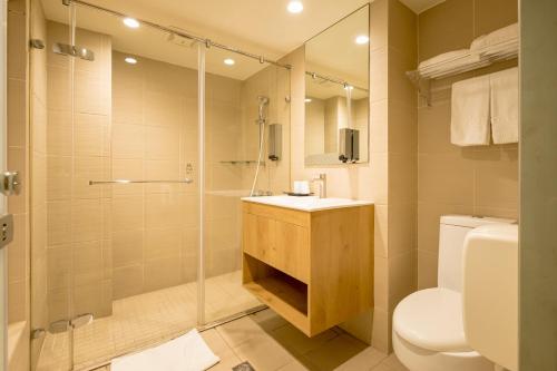 a bathroom with a shower and a toilet and a sink at VIP Hotel in Taipei