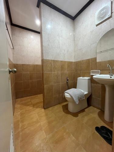 a bathroom with a toilet and a sink at Harmony Place at Hillside in Puerto Princesa City