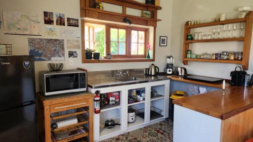 a kitchen with a sink and a tv on a counter at Twin Kauri's 94 in Cambridge
