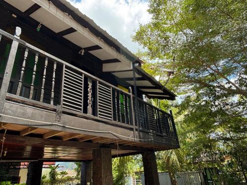 a house with a balcony on the side of it at Gio Private Villa - Langkawi in Langkawi Intl