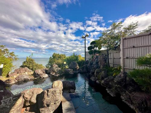 a pool of water with rocks in a yard at Donkairo in Ako