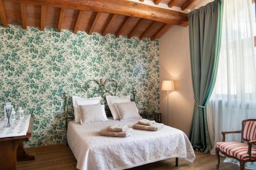 a bedroom with a bed with two towels on it at Fienile in Pontassieve