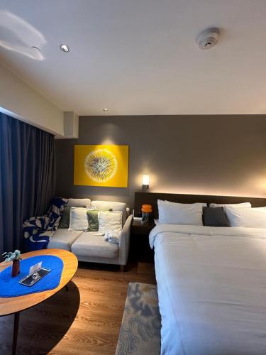 a hotel room with two beds and a table at Hotel Residence at Novotel in Manila