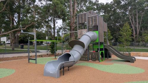 a playground with a slide in a park at Kookaburra Place in Thornleigh