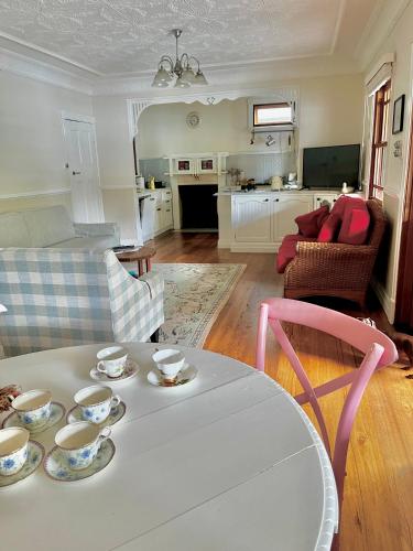 a living room with a table with cups and saucers on it at The Haven Cottage Point Sydney